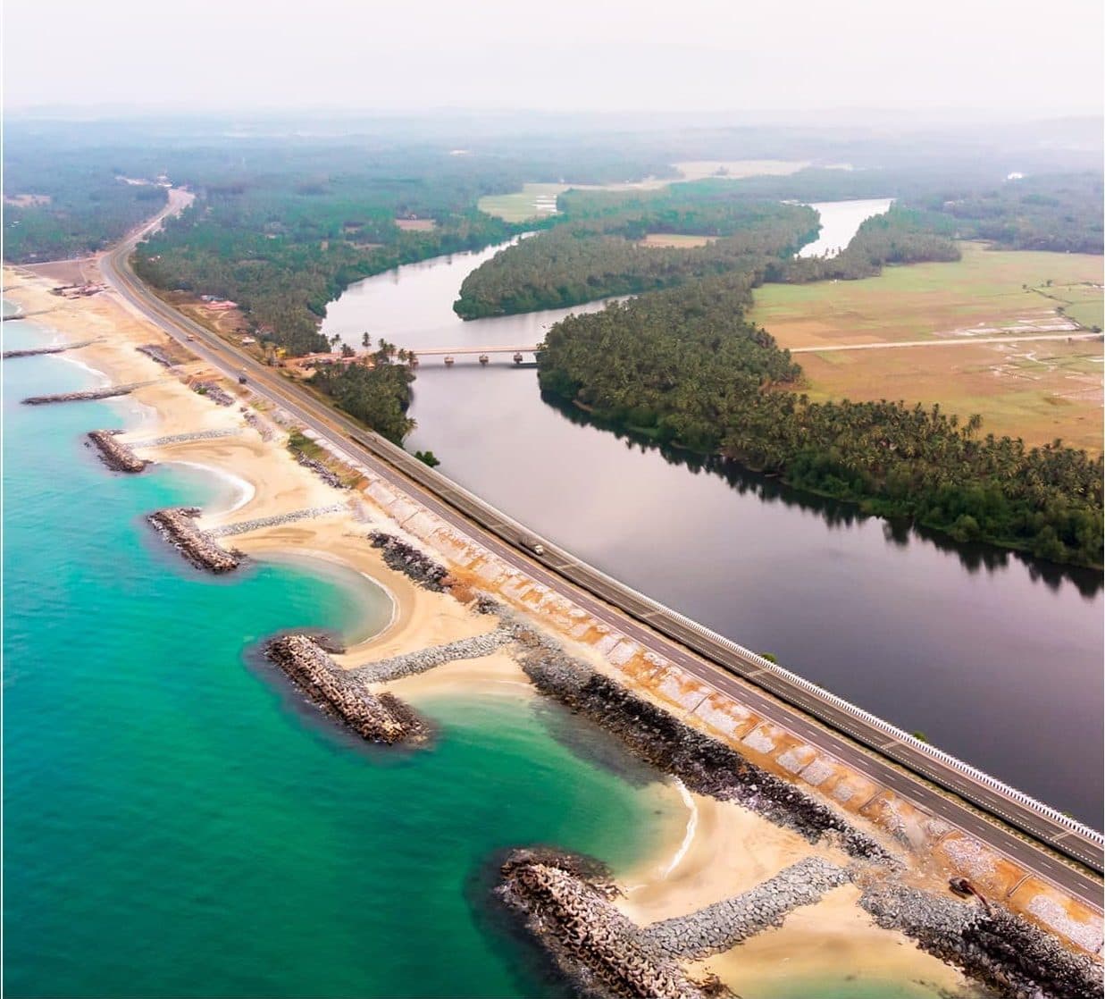 The narrow Maravanthe strip from above, the Arabian Sea on one side and the Souparnika river and green fields on the other