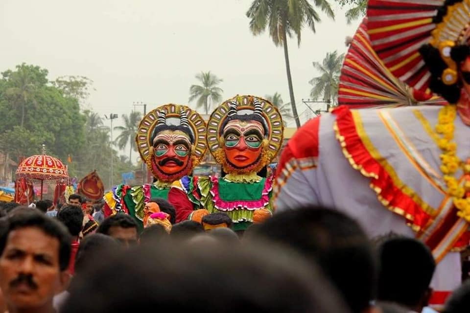 Masked Daiva performers in a festival procession