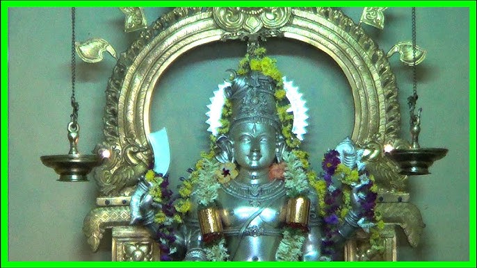 The silver-clad combined deity of Shankaranarayana, Shiva and Vishnu in one form, within an ornate arch